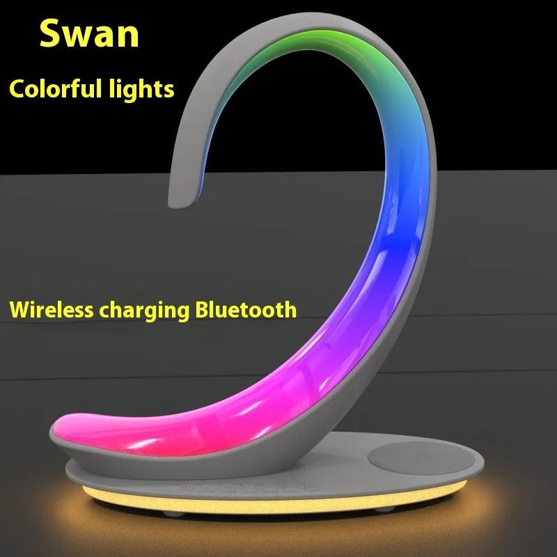 White swan shaped desktop lamp with wireless charging pad, Bluetooth speaker and colourful LED mood lighting