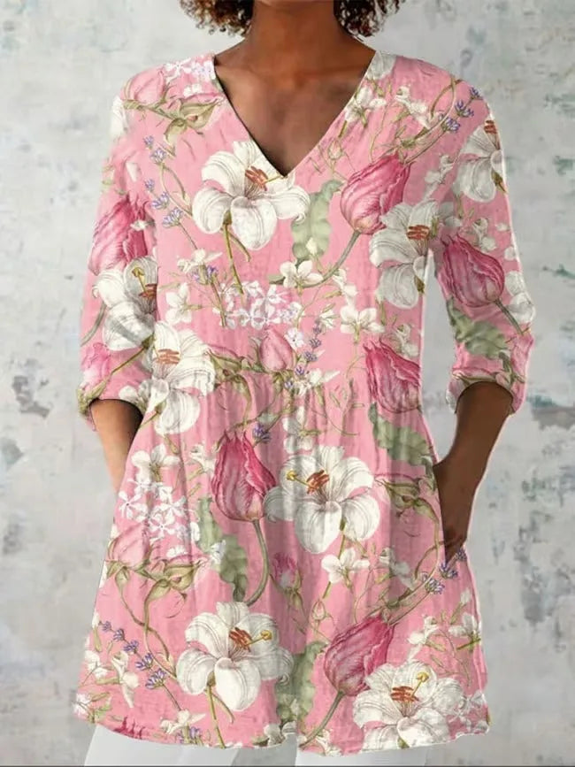 Woman wearing a retro slim fit, digitally printed long-sleeved top in a floral design.