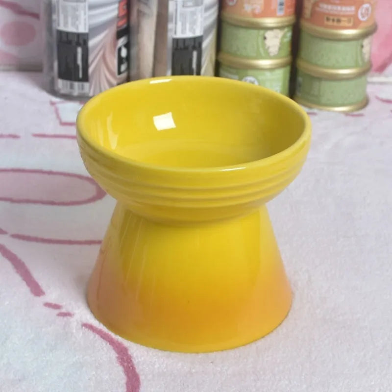 A white ceramic pet bowl with a high foot and raised neck protector to prevent tipping.