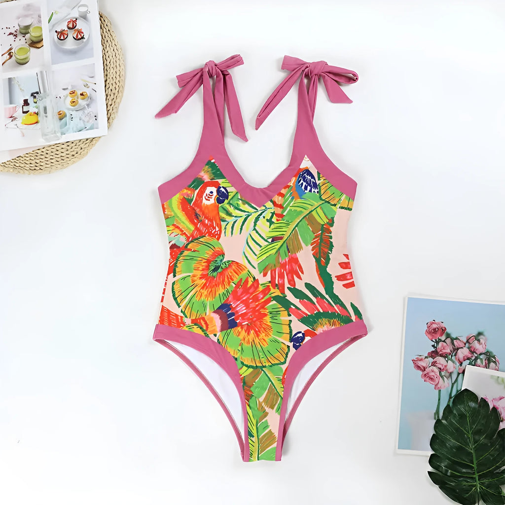 Pink floral print one-piece swimsuit with V-neck, covered belly, and an attached skirt.