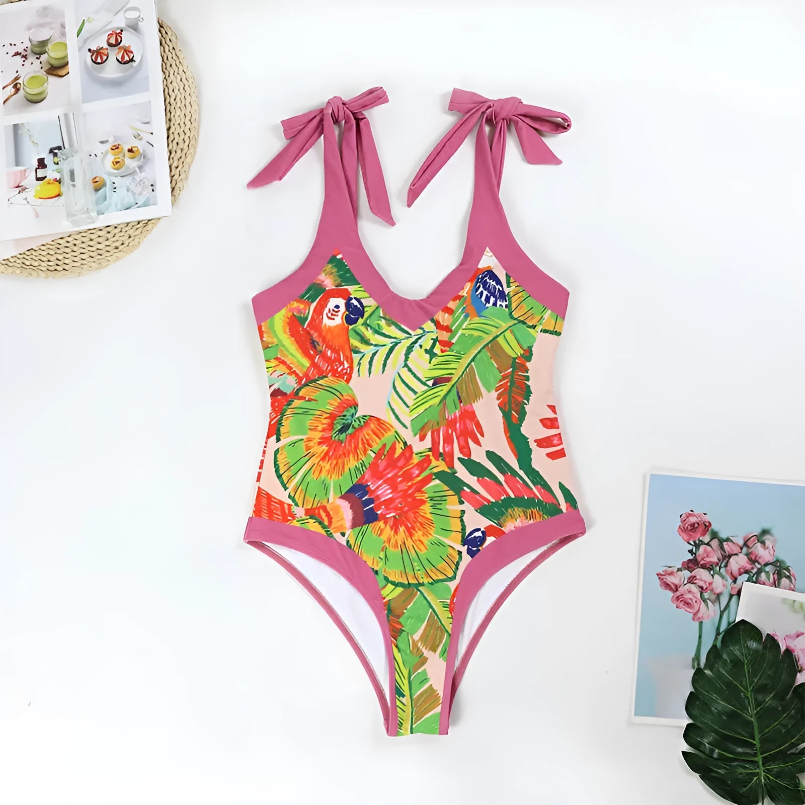 Pink floral print one-piece swimsuit with V-neck, covered belly, and an attached skirt.