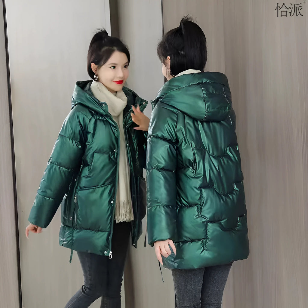 Women's loose fit hooded winter jacket in green colour showing long sleeves and thick insulation