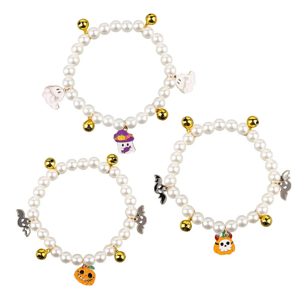 Halloween cat collar with simulated pearls and pumpkin charms in purple ghost, skull, and smiling designs