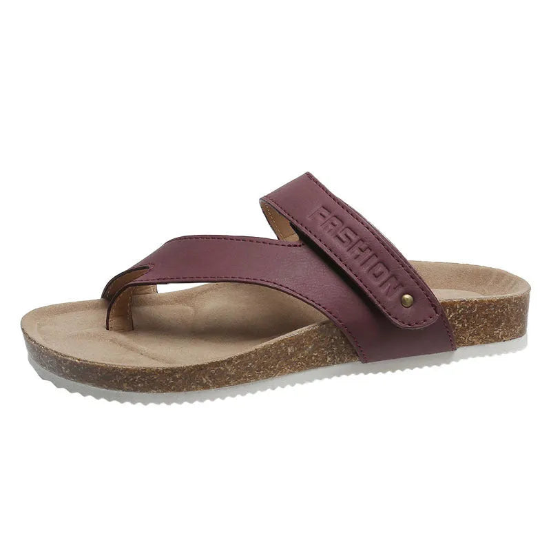 A pair of flat toe ring thick-soled flip-flops in a solid colour on a plain background.