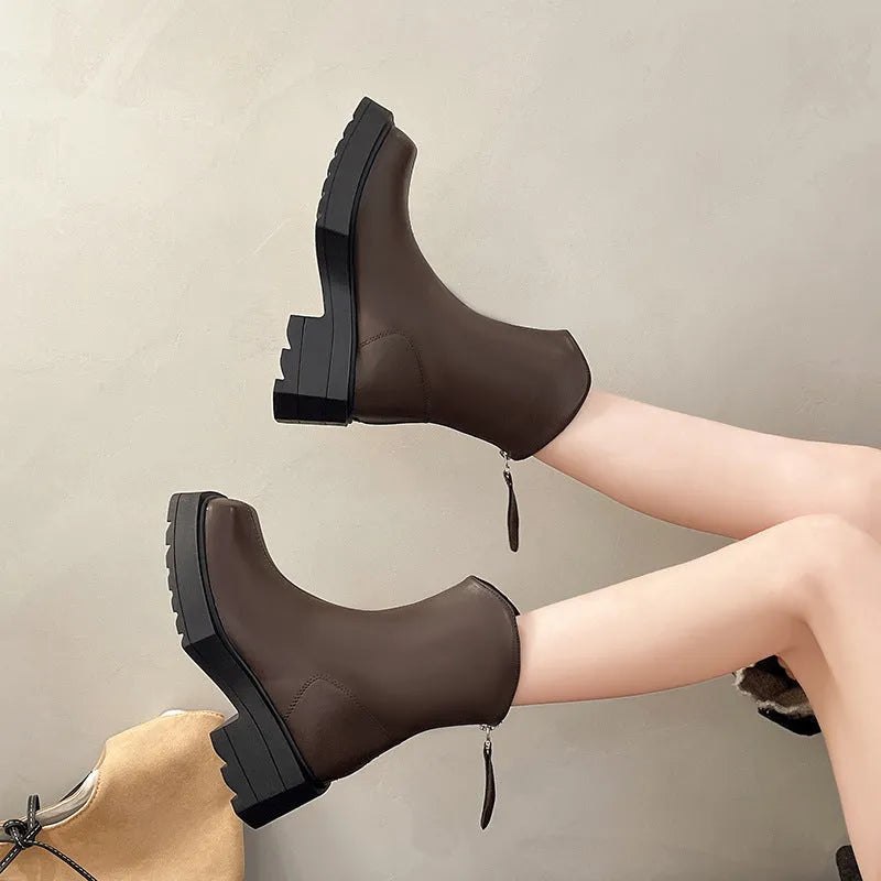 Black platform Martin boots for women with square toe, high heel, and back zip on a white background.
