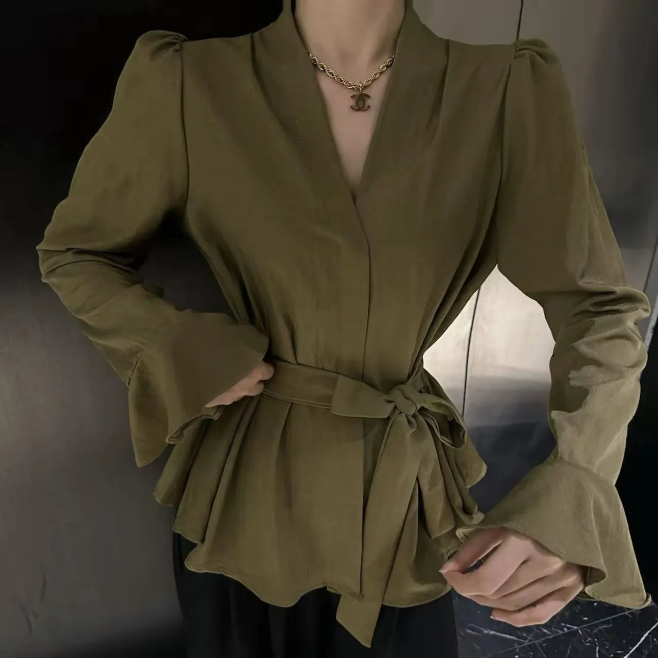 Women's French-style irregular collar shirt with long bell sleeves and tie front detail in polyester fabric.