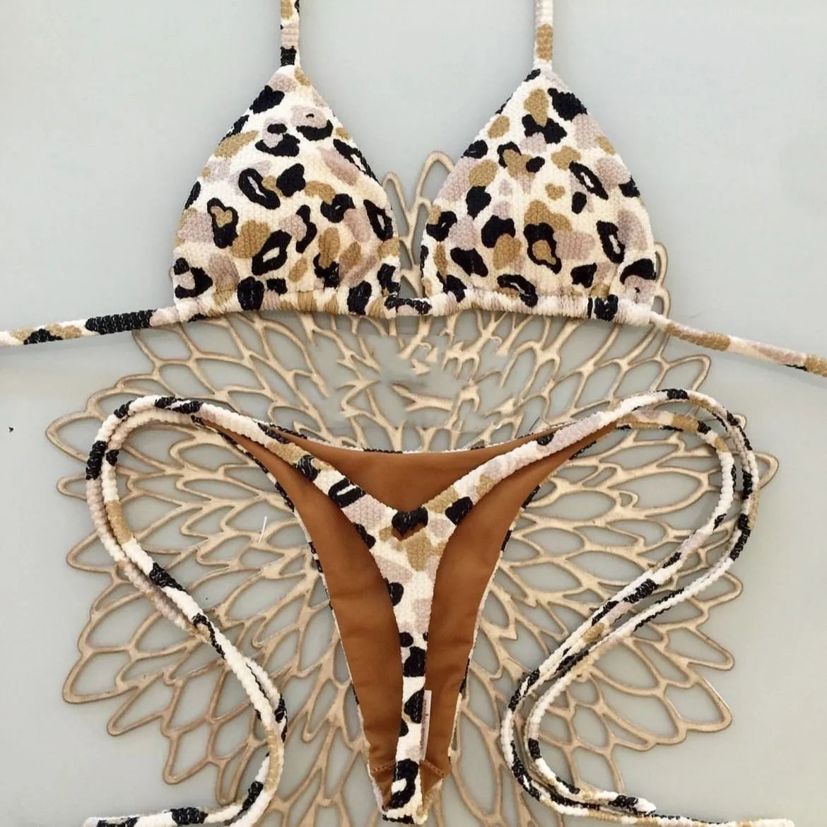 Women's bikini swimsuit with printed fabric in briefs style, showing high elasticity and cotton lining