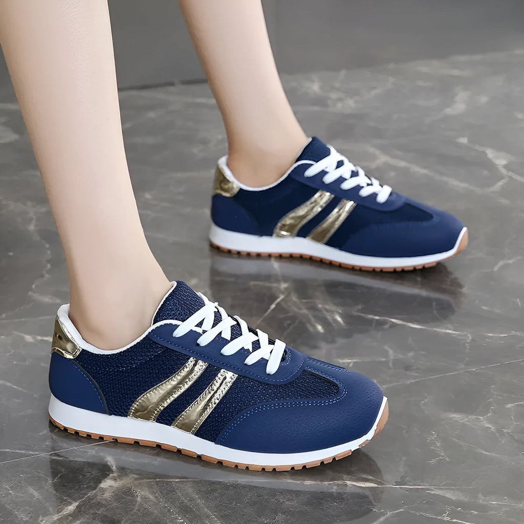 Blue women's tennis shoes with cross shoulder straps and lace-up front, artificial leather fabric uppers