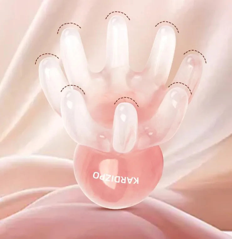Pink octopus-shaped natural resin massage comb for facial and head massage on a plain background.
