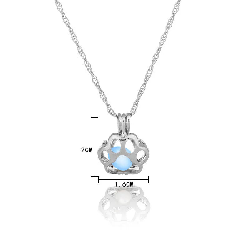Hollow dog paw luminous alloy necklace with bamboo link chain and pendant, blue green colour option on white background