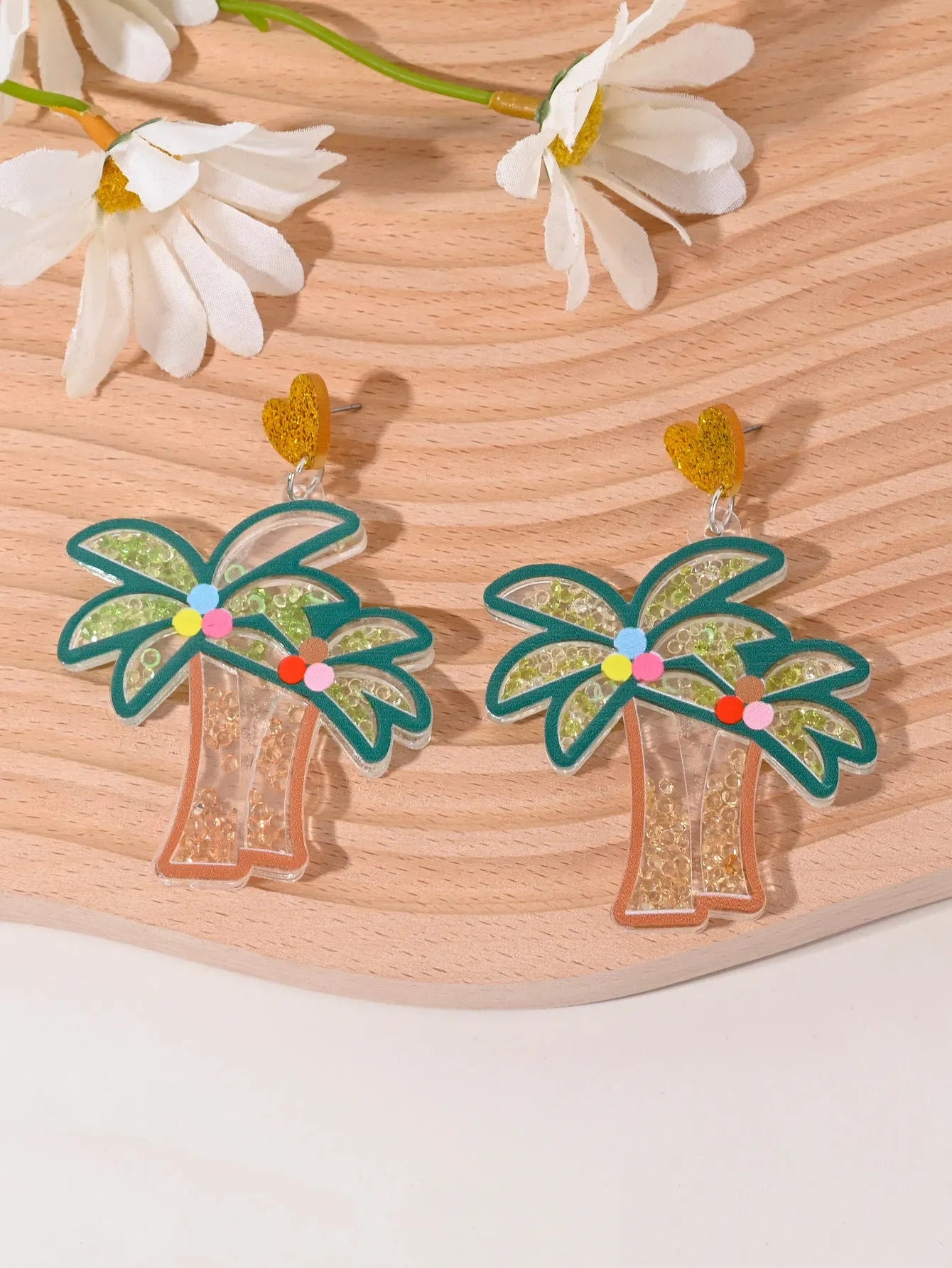 Colourful acrylic novelty earrings shaped like fruits and desserts including cherry, strawberry, and ice cream.