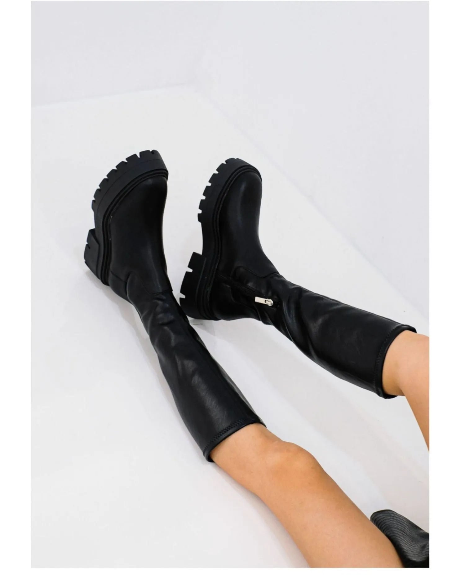 Women's black high leg stretch boots with round toe, non-slip rubber sole, and mid heel on a clean background.