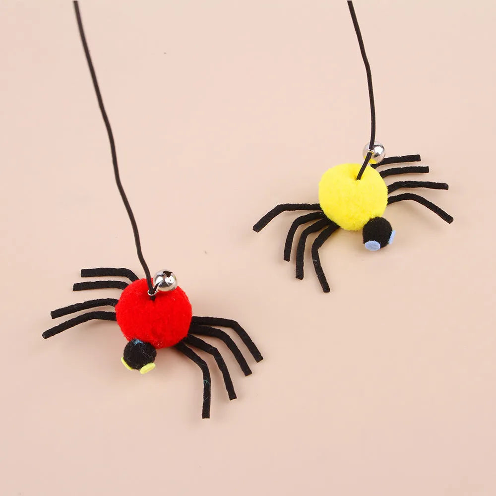 Red and yellow hanging cat toy with elastic rope, feather, bell, and spider elements for door mounting