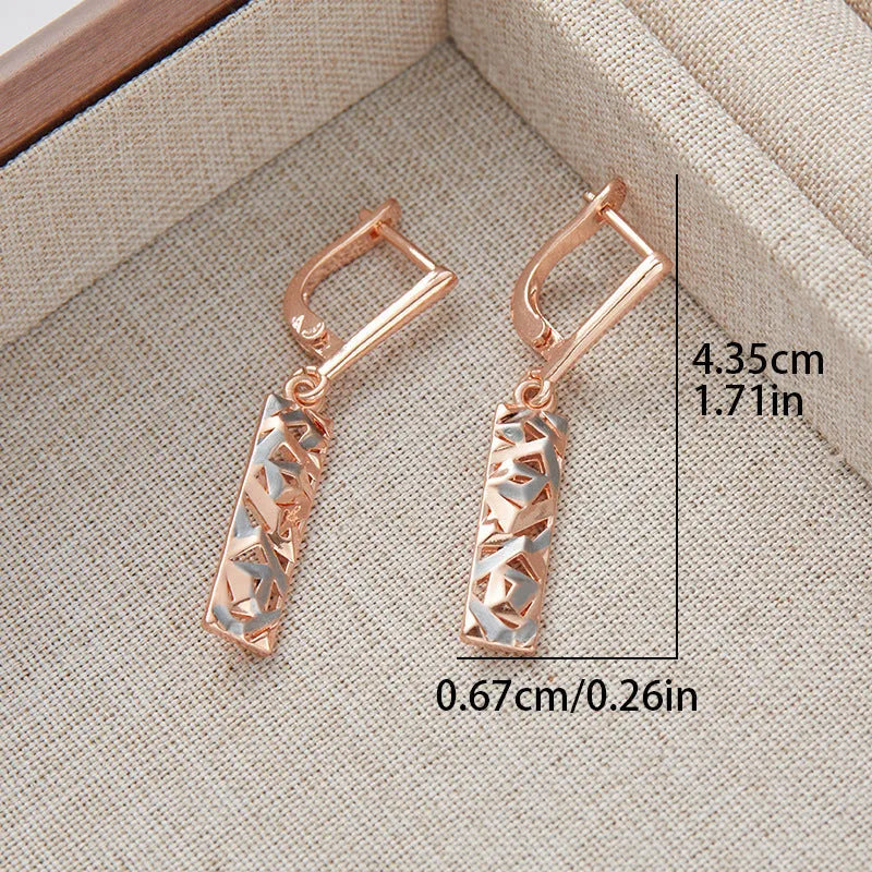 A pair of women's rectangular two-tone hollow stud earrings with a geometric design.