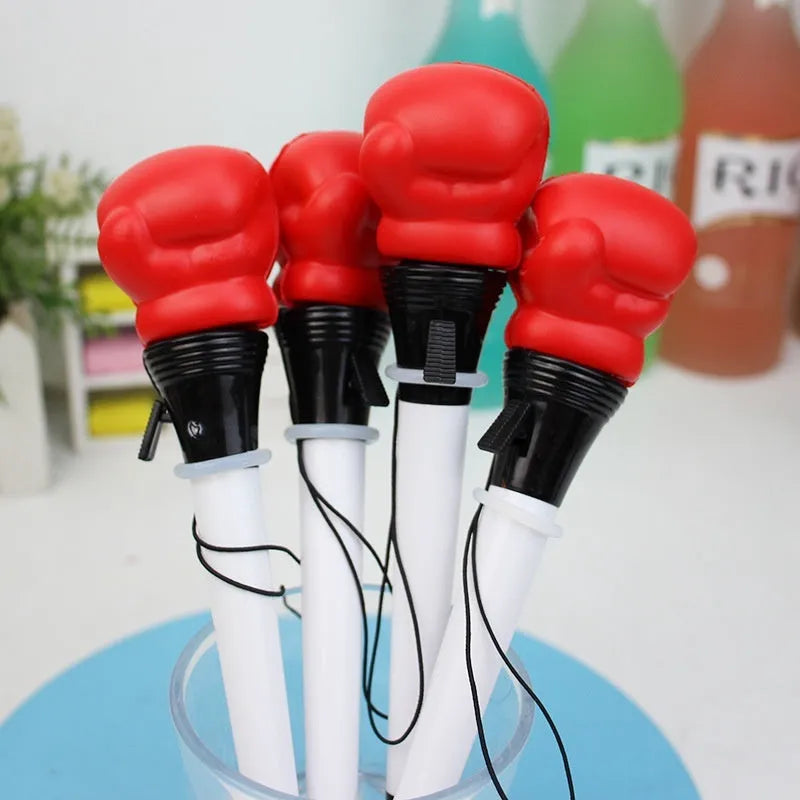 Set of four black ejection pens with a pressure relief boxing press button on the barrel.