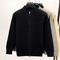 Man wearing a beige high collar zip-front knit cardigan, loose fit, long sleeves.