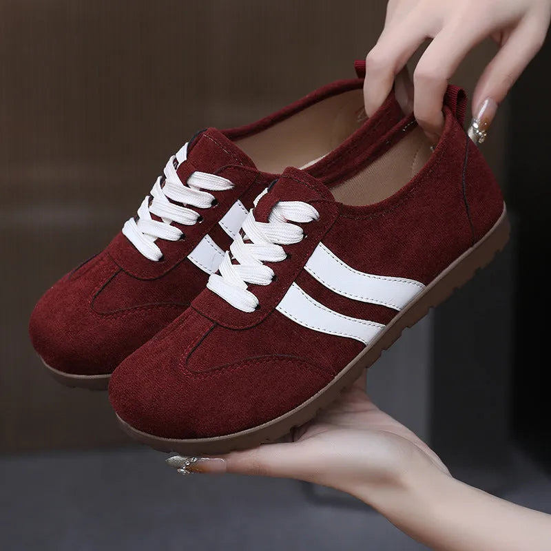 Women's vintage canvas sneakers in dark red with a round toe and soft rubber sole.