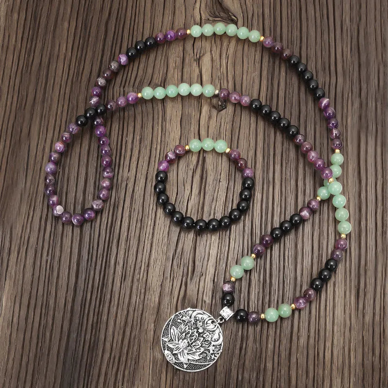Lotus pendant necklace with stone beads on adjustable ball bead chain alongside matching bracelet