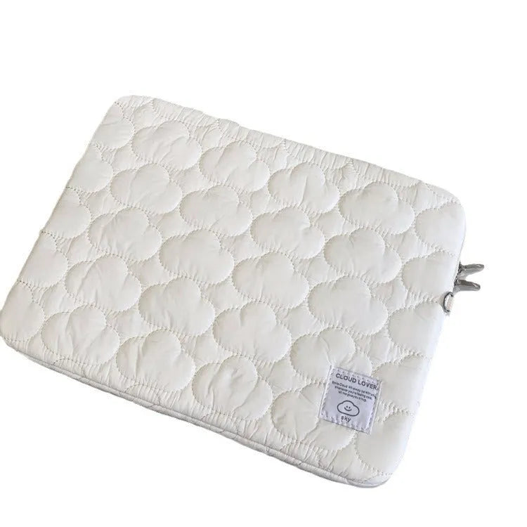 White cotton notebook storage bag with blue cloud embroidery on a table