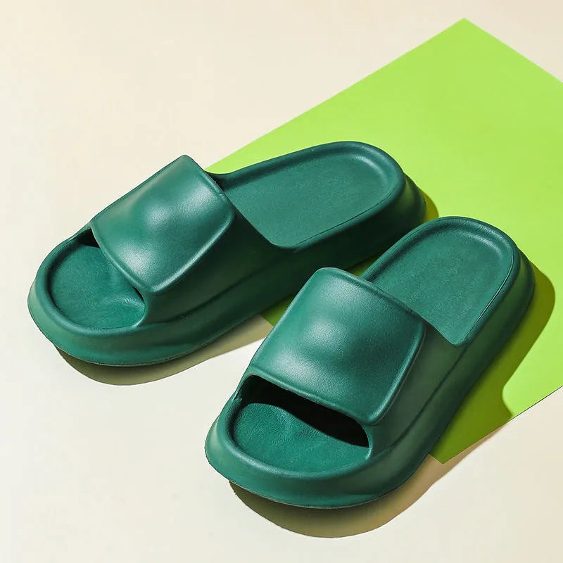 Pair of thick-soled EVA flip flop slippers in purple, showing deep sole profile.