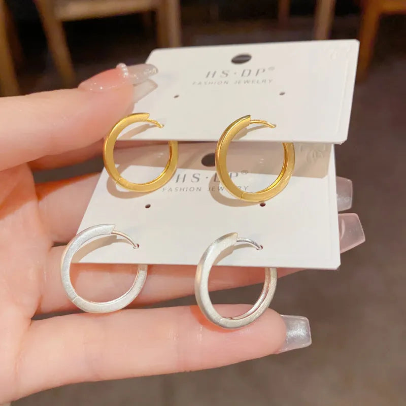 Geometric women's ear clips with gold plating and round eyelet design on copper material