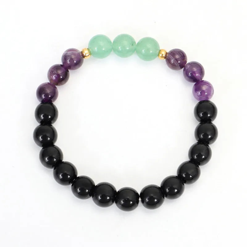 Lotus pendant necklace with stone beads on adjustable ball bead chain alongside matching bracelet