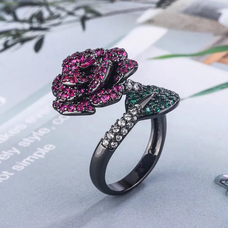 Black gold plated geometric floral ring with a red simulated corundum stone for women.