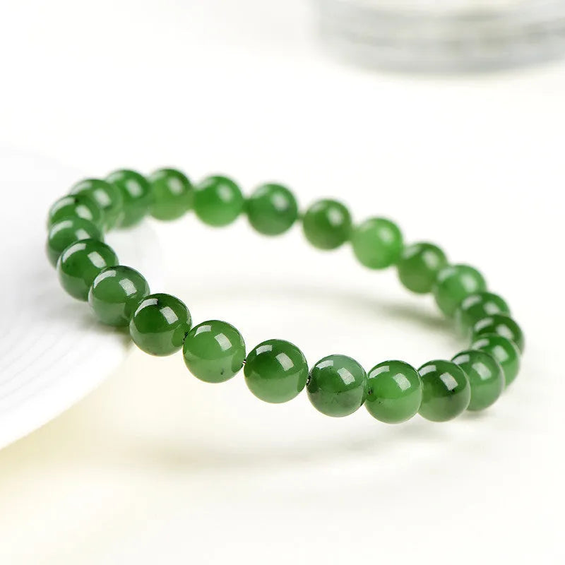 Natural Hetian jade bead bracelet in jasper colours, showing polished beads on a wrist.