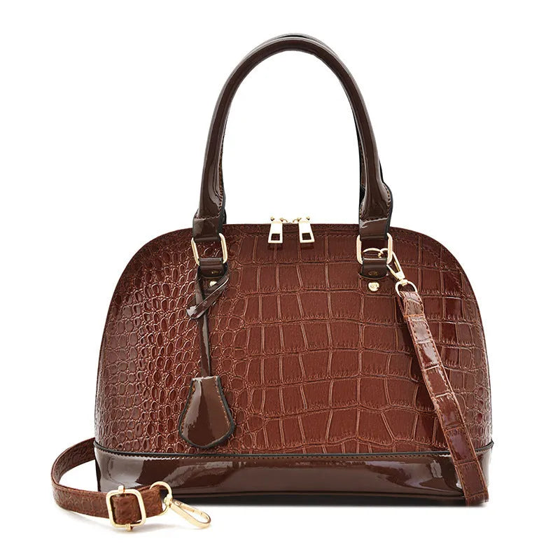 Large shiny black PU shoulder bag with crossbody strap showing interior polyester lining