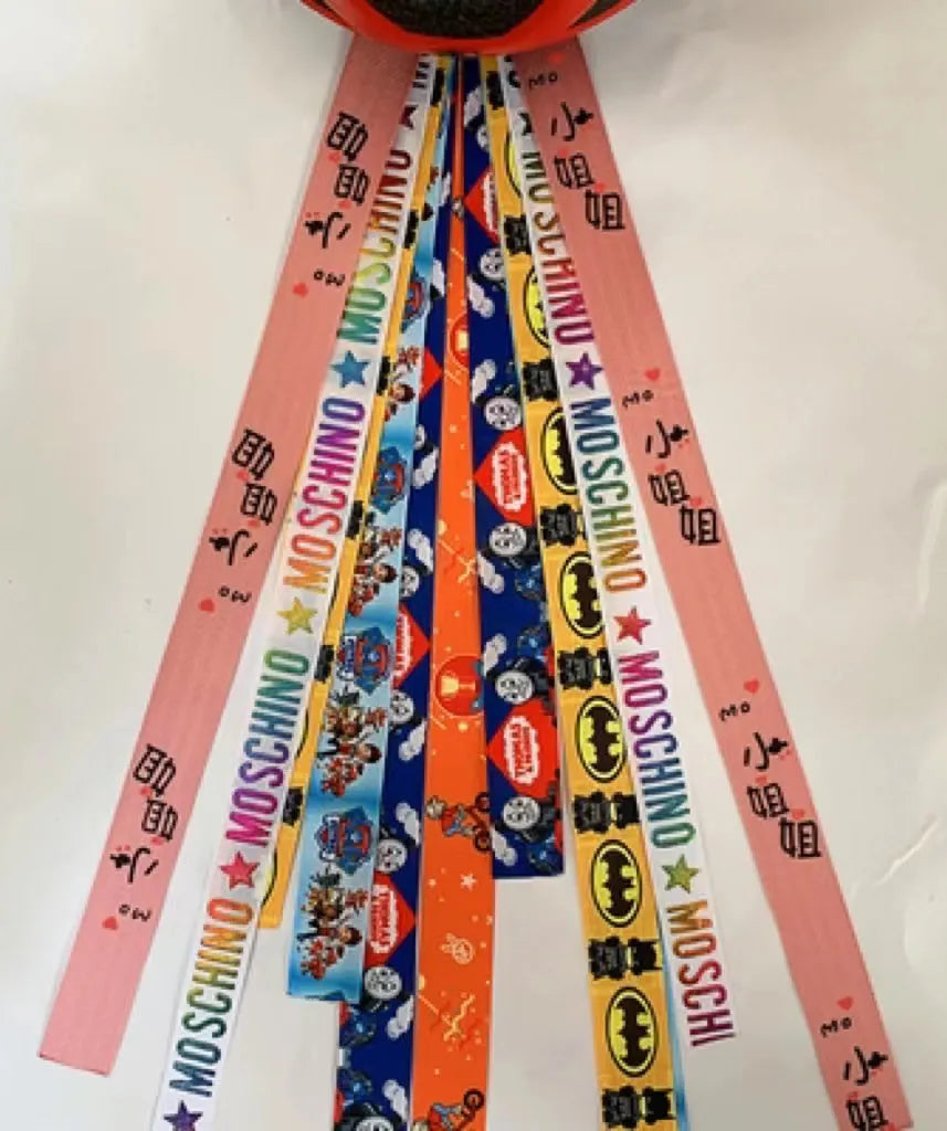 Close-up of a colourful decorative ribbon streamer attached to a child's helmet for roller skating or skiing.