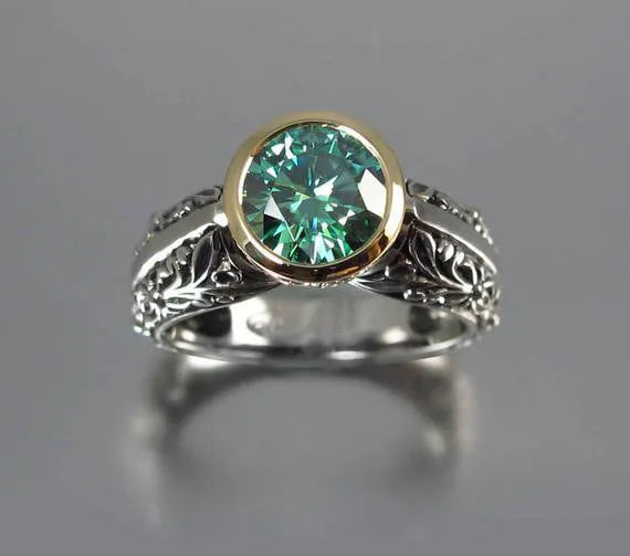 Gold-plated flower-shaped ring with emerald green gemstone in vintage design on finger