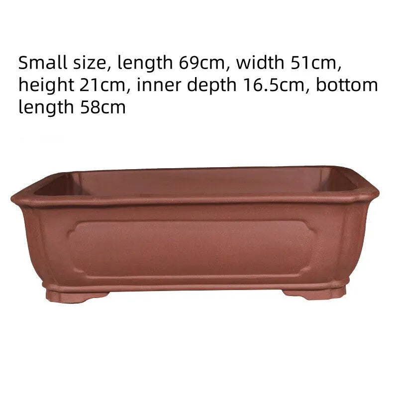 Large rectangular purple clay flowerpot with traditional handmade appearance and drainage holes