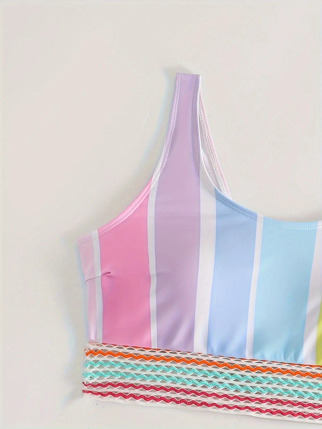 Women's striped two-piece bikini set in a sports casual design on a mannequin.