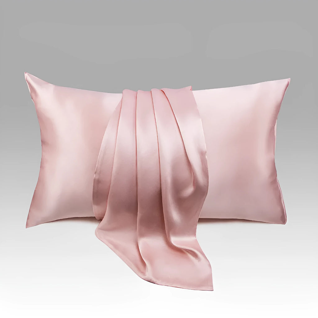 Dark grey silk pillowcase with envelope closure on a bed