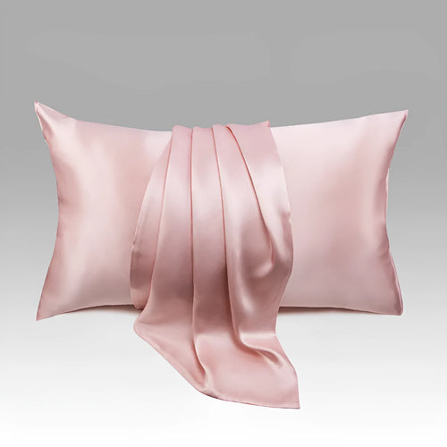 Dark grey silk pillowcase with envelope closure on a bed