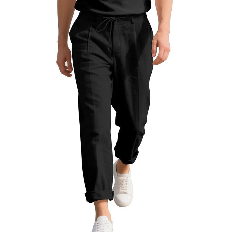 Men's light khaki linen casual trousers with a straight leg and drawstring waistband laid flat.
