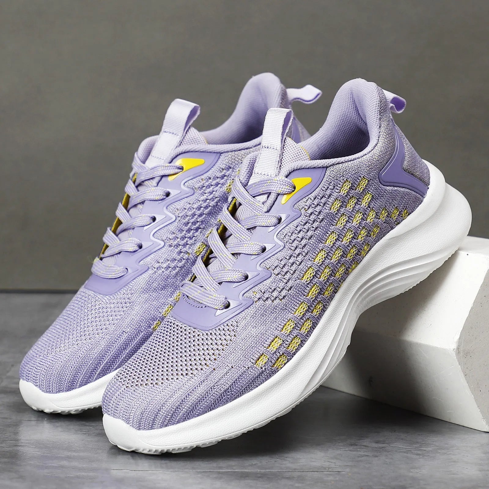 Women's lavender purple Flyknit running shoes with mesh fabric and striped pattern