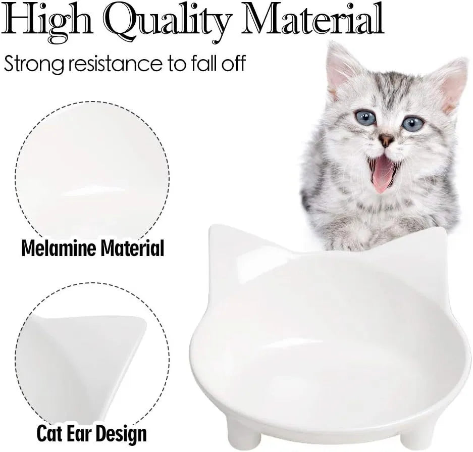 Set of four shallow black and white cat bowls with non-slip bases on a kitchen counter
