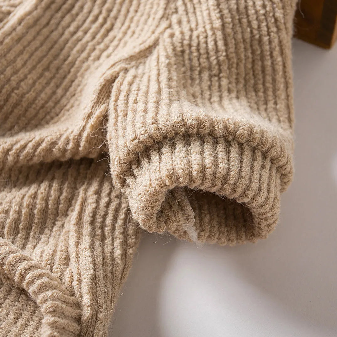 Brown knitted pullover sweater on a small dog, showing four-leg design for full coverage.