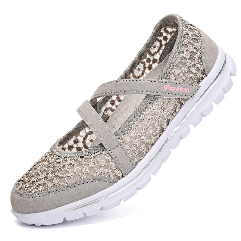 Women's beige lace-up casual flats with mesh upper and round toe on a light background.