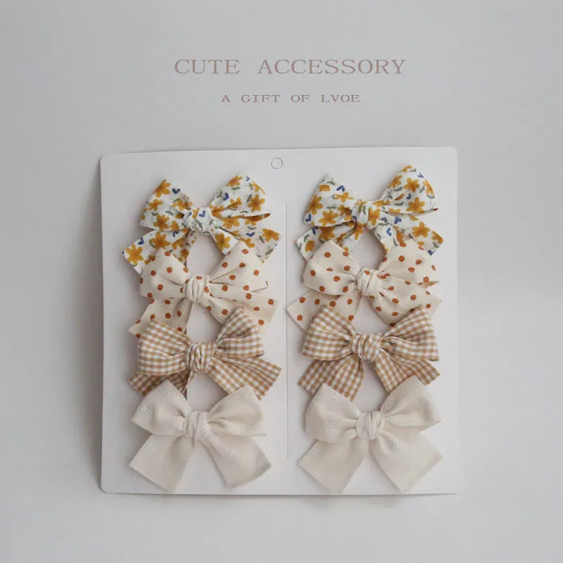 Children's eight-piece cloth bow hairclip set in dovetail shape with multiple colour options