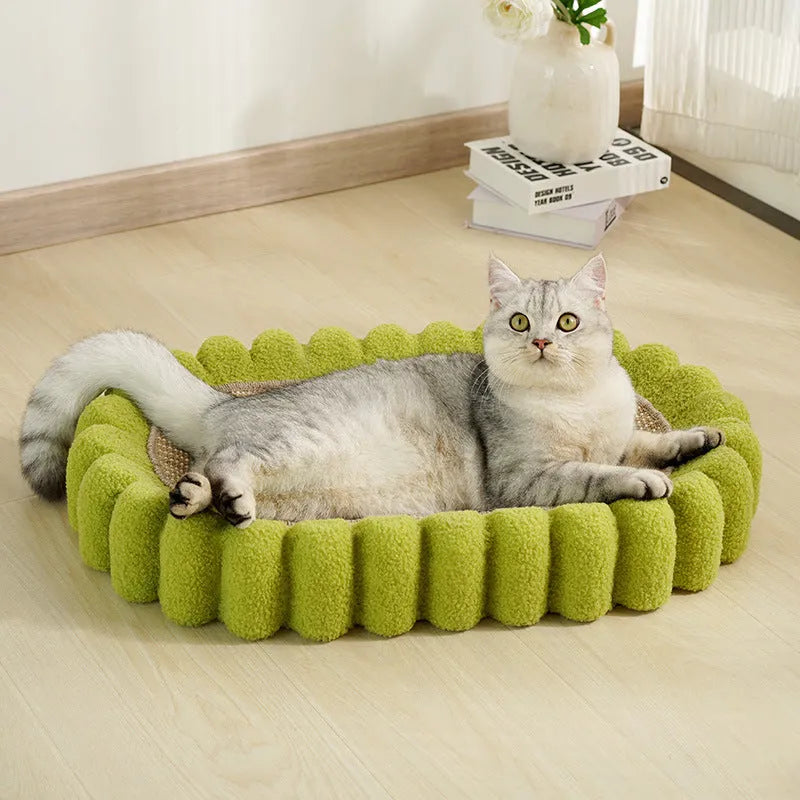 Green oval cardboard cat scratching pad with sisal surface, serving as a cat bed.