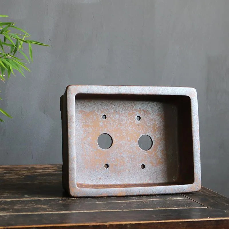 Rectangular purple sand bonsai flowerpot with firewood burning finish on wooden floor