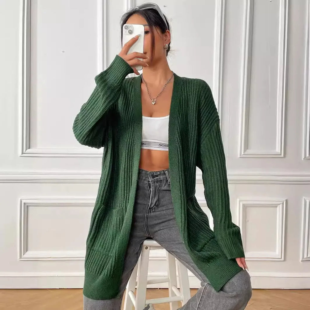Women's dark green double pocket cardigan with long sleeves and loose fit.