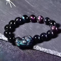 Natural ice colour obsidian crystal bracelet showing pale stone beads on wrist