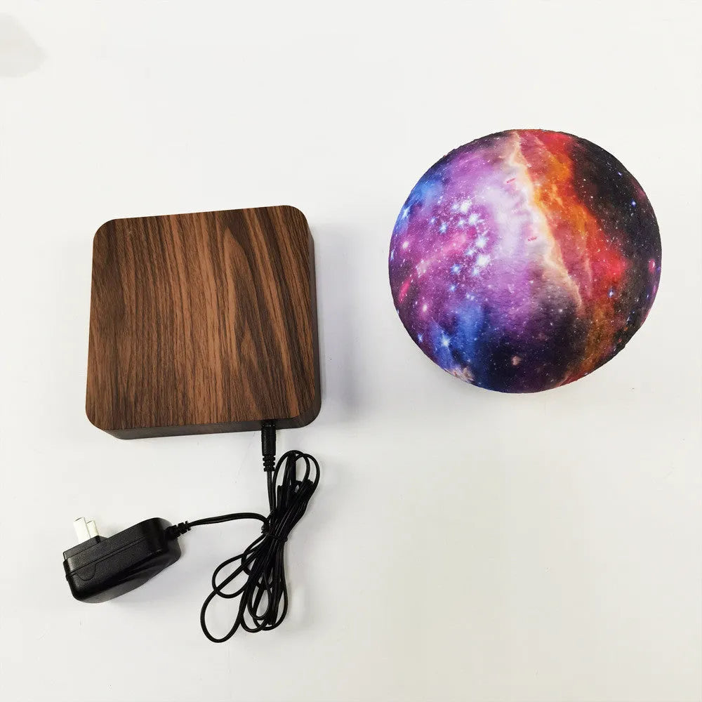 Square walnut coloured magnetic levitation galaxy moon lamp floating above its base