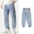 Men's loose-fit tapered cotton trousers in black colour showing mid-rise waist and tapered leg silhouette