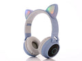 Pink cartoon cat ear wireless Bluetooth headset with headband, shown on a white background.