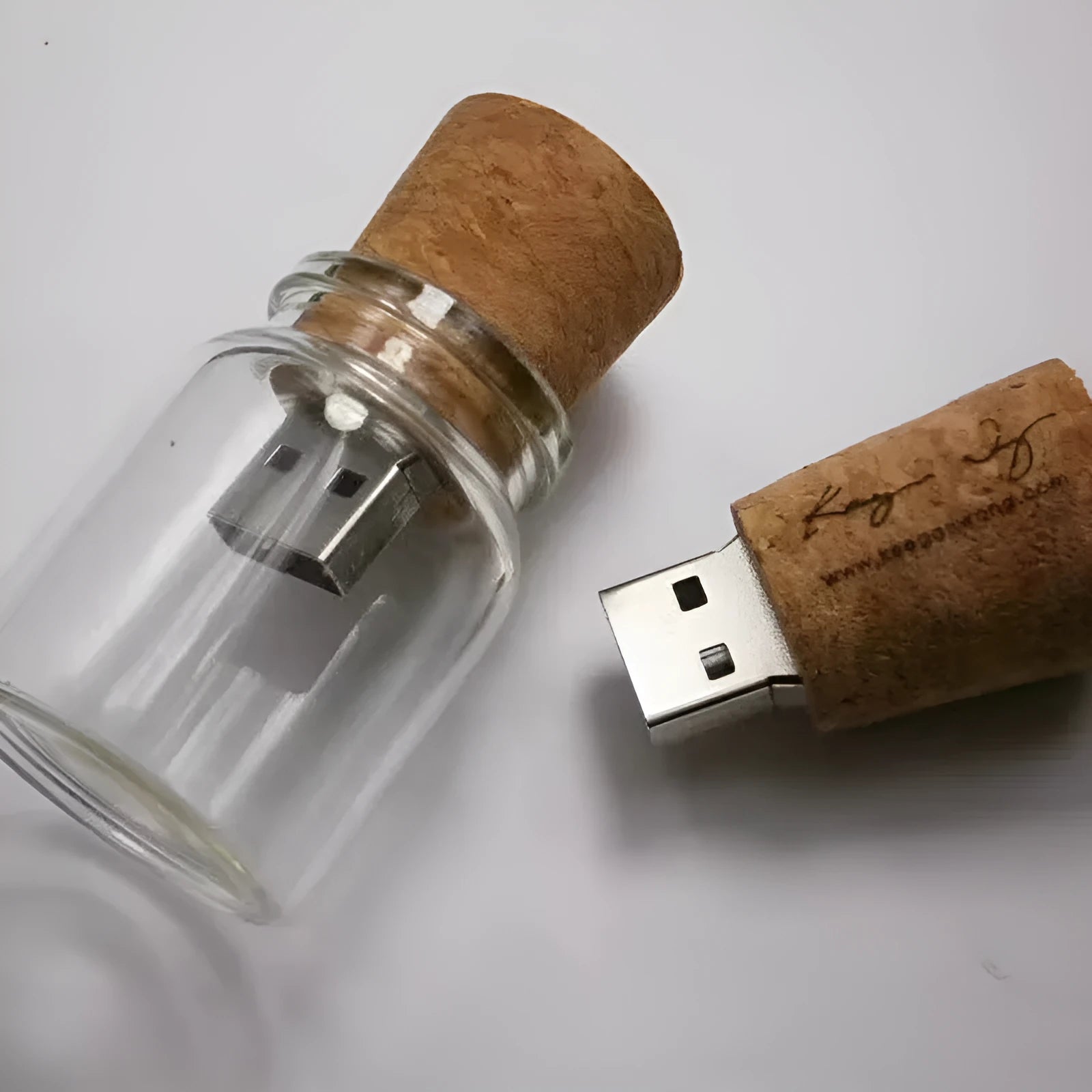 Clear glass bottle USB flash drive with wooden cap showing internal component