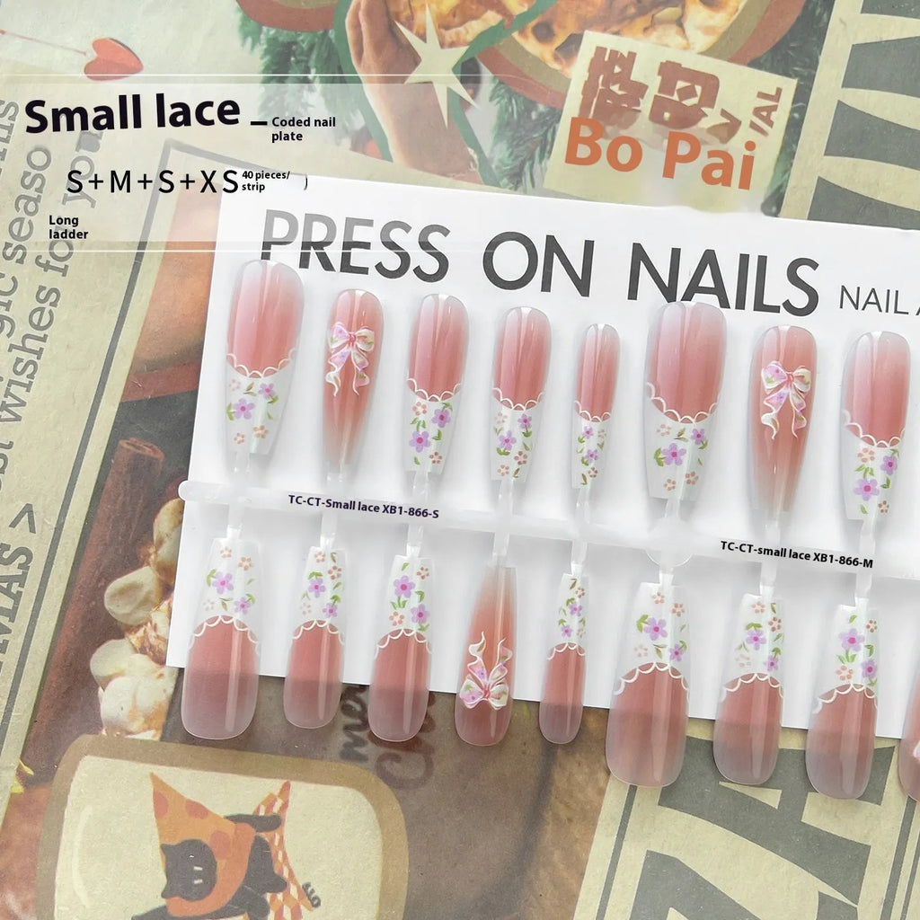 Set of 40 small floral prefabricated nail tips with long ladder velvet seal layer in white, displayed on a flat surface